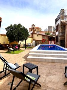 a patio with chairs and a swimming pool at La Casa del Marqués in Logrosán