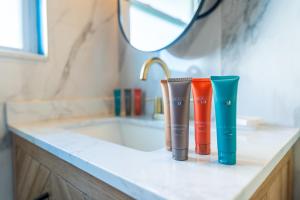 three different colored bottles sitting on a bathroom counter at Tropical Breeze Vacation Rentals in Clearwater Beach +216 photos