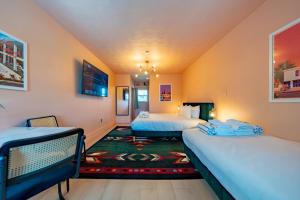 a room with two beds and a rug at Tropical Breeze in Clearwater Beach