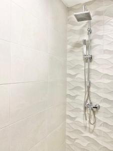 a shower with a shower head in a bathroom at Central Seaview Apartments for 4 Guests in Sveti Vlas