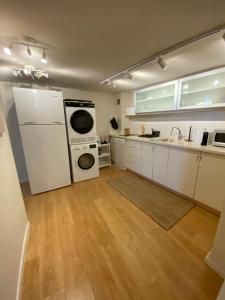 a kitchen with a white refrigerator and a stove top oven at spacious real two bedrooms at the daniel hotel in Herzelia 