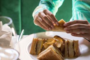 a person holding a piece of bread on a plate at Hotel La Gemma in Florence