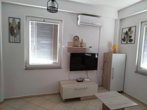 a living room with a tv and a refrigerator at 2K Apartment in Ohrid