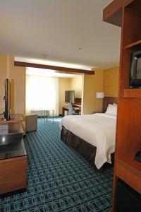 a hotel room with a bed and a television at Fairfield Inn & Suites by Marriott London in London