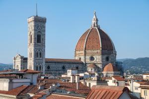 a view of a cathedral and roofs of buildings at Hotel La Gemma in Florence
