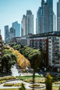 a view of a city with tall buildings and trees at SLS Buenos Aires Puerto Madero in Buenos Aires