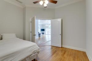 een witte slaapkamer met een bed en een plafondventilator bij Single-Story Home about 7 Mi to Old Towne Conyers! in Conyers