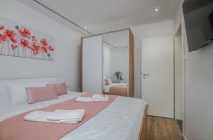 a bedroom with a bed with two towels on it at Apartment Aurora Island Krk Malinska in Sveti Anton