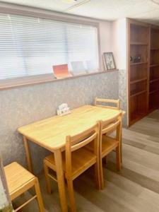 a wooden table and chairs in a room at 2 BD Suite & Separate Entrance West Kelowna in West Kelowna