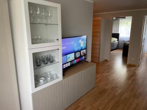 a living room with a flat screen tv on a wall at Korter Tõrvas Valga mnt 66 in Tõrva
