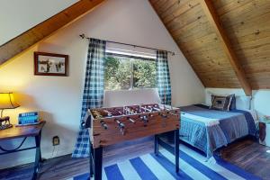 a bedroom with a foosball table in front of a bed at House of the Rising Sun in Lake Arrowhead