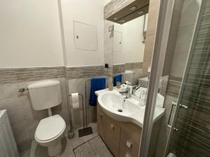 a bathroom with a toilet and a sink and a shower at OltreMare - San Salvo Marina in Marina di Montenero