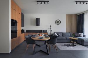 a living room with a table and a couch at Apartament 1N2 taras z widokiem - Sun&Sport in Szczyrk