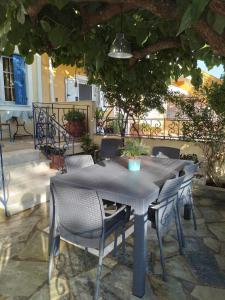 a table and chairs sitting under an umbrella at Kali’s comfort in Karavomylos