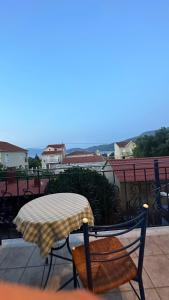 a table and chair with an umbrella on a balcony at Kali’s comfort in Karavomylos