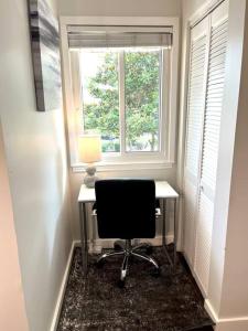 Habitación con ventana y escritorio con silla. en Modern Rocket City Condo -- 3 min to Mid-City en Huntsville