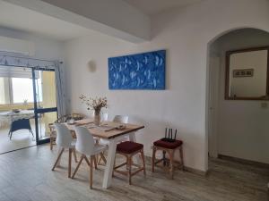 a dining room with a table and chairs at SALTY SANDY in Lagos