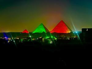 a group of pyramids lit up at night at Celia Pyramids View inn in Cairo