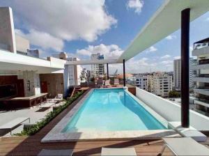 a swimming pool on the roof of a building at Luxury 1 BDR , Rooftop POOL, Gym, in Downtown D2 in Santo Domingo