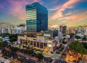 a tall building in a city with a lot of traffic at Luxury 1 BDR , Rooftop POOL, Gym, in Downtown D2 in Santo Domingo