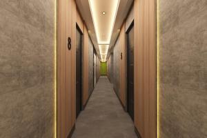 a hallway with wooden walls and a long corridor with doors at Leaf River Suites in Antalya