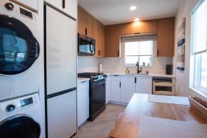 a kitchen with white appliances and a wooden floor at 5079 Lotus Street in San Diego