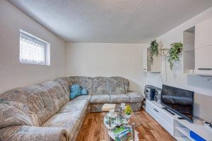 a living room with a couch and a tv at Holiday home Veki*** in Korenica