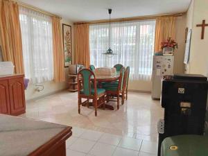 a kitchen with a dining room table and chairs at Private Villa with Swimming Pool in Babakan Madang