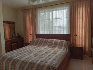 a bedroom with a bed and a large window at Private Villa with Swimming Pool in Babakan Madang +16 photos