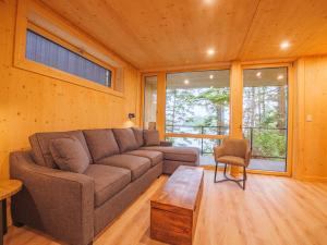 a living room with a couch and a table at The Cabins at Terrace Beach in Ucluelet