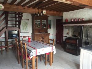 a kitchen with a table and chairs in a room at Petite maison in Planchez