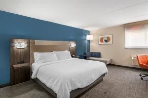 a hotel room with a bed and a blue wall at Holiday Inn Express Greencastle, an IHG Hotel in Greencastle