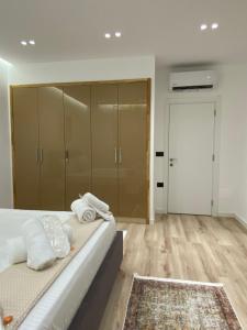 a bedroom with a bed with towels on it at Exquisite by Broci Apartments in Tirana