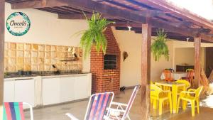 a kitchen with yellow chairs and a table in a room at Oncotô Palmas Hostel in Palmas