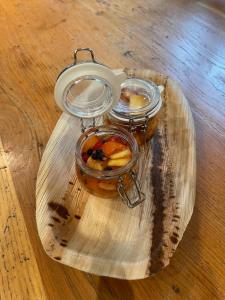 una placa de vidrio con dos tarros de comida en una mesa en CHAMBRES D'HÔTES LES CHAMBRES D'ELSA, en Albiez-Montrond