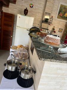 a kitchen with a counter with food on it at Hospedagem Clã dos Couto - Pousada in Saquarema