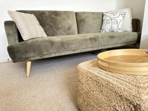 a living room with a couch and a coffee table at Central City Beach Pad in Brighton & Hove