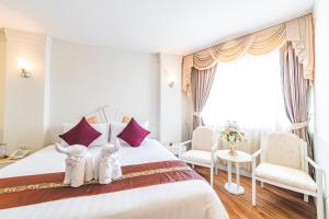 מיטה או מיטות בחדר ב-Thong Tarin Hotel