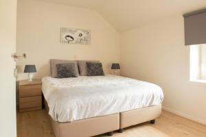 a bedroom with a large bed in a room at Het Landsleven in Gingelom