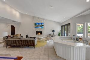 a living room with a couch and a fireplace at Our Poolside Desert Nirvana in Palm Springs