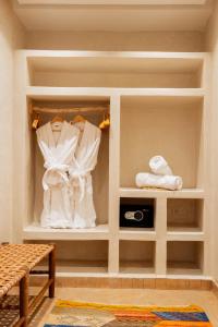 un vestidor con ropa blanca en los estantes en Le Palais Averroes - Adults Only en Marrakech