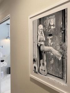 a black and white photo of a little girl with a guitar at Our Poolside Desert Nirvana in Palm Springs