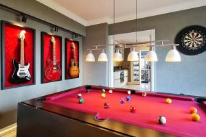 a pool table in a living room with pictures of guitars at The Best Experience in Ankara in Ankara