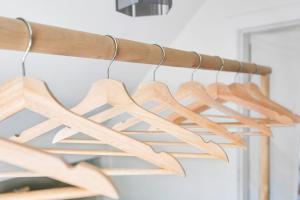 a bunch of wooden hangers hanging from a rack at Minimal - 30 nights minimum in Vancouver