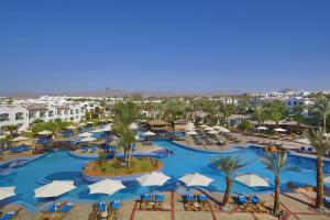 an aerial view of a resort swimming pool with umbrellas at Hotel studio in Sharm El Sheikh