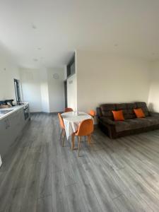 a living room with a table and chairs and a couch at Hill Top View Apartment Lahinch in Lahinch