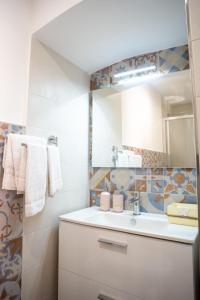 a bathroom with a white sink and a mirror at Il Germoglio in Bisceglie