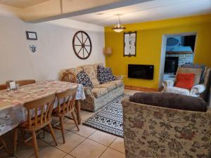 a living room with a table and a couch at Rose Cottage - Cosy cottage in Millers Dale in Buxton