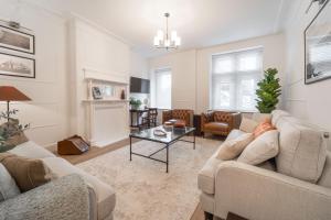 a living room with two couches and a table at 8 The Quadrant Luxury Apartments - Hoylake in Hoylake