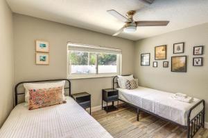 a bedroom with two beds and a window at Vero Beach Vacation Rental Pool and Putting Green! in Vero Beach +22 photos
